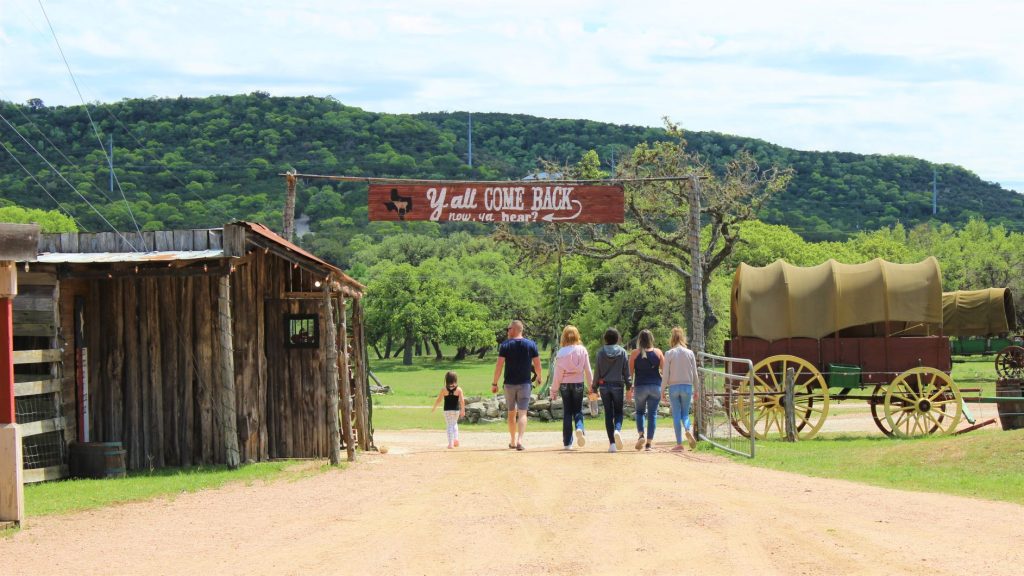 A family exits Enchanted Springs Ranch