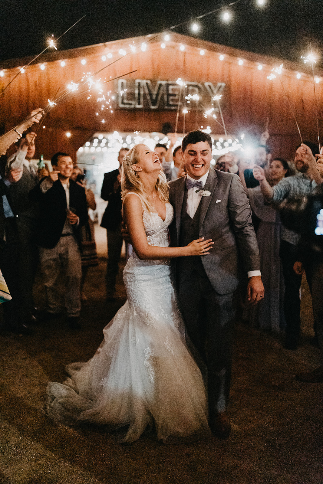 A couple exits their wedding with a sparkler send off