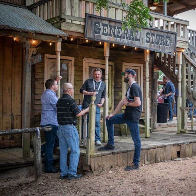 Guests talking on the General Store porch during an outdoor corporate event