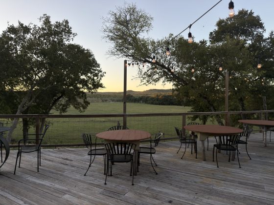 Cocktail tables on the Silver Spur back patio at sunset overlooking the Back 40
