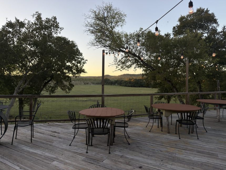 Cocktail tables on the Silver Spur back patio at sunset overlooking the Back 40