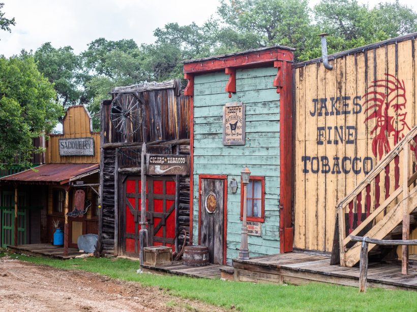 The side exterior of the Six Gun Saloon on the Old West town street
